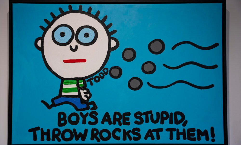 Todd Goldman painting showing a cartoon boy throwing rocks beside the words Boys Are Stupid, Throw Rocks at Them